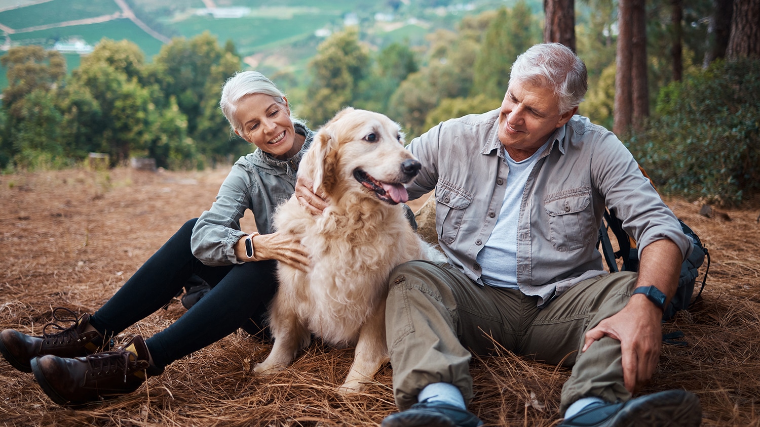 Couple Hiking With Their Dog