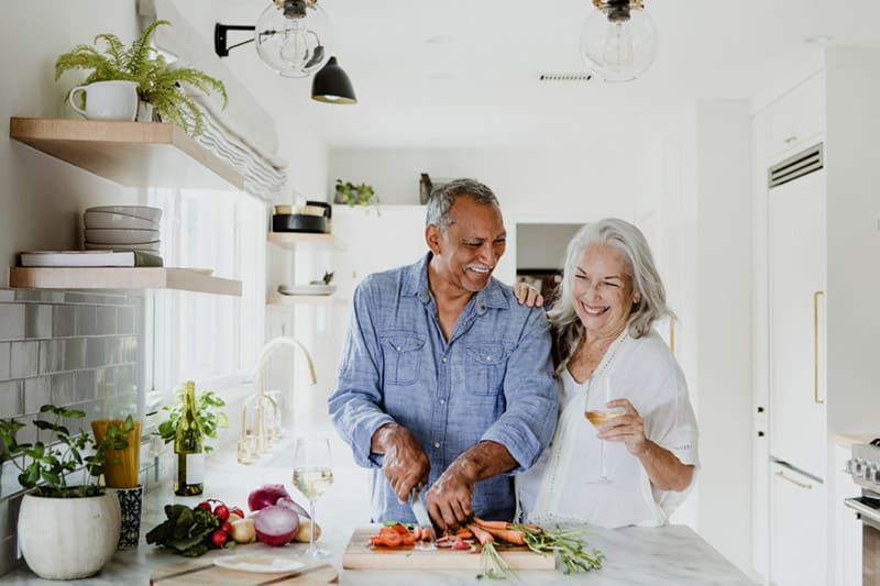 Couple cooking in the kitchen together, laughing