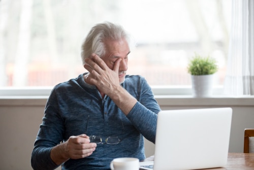 Older man rubbing his dry eyes