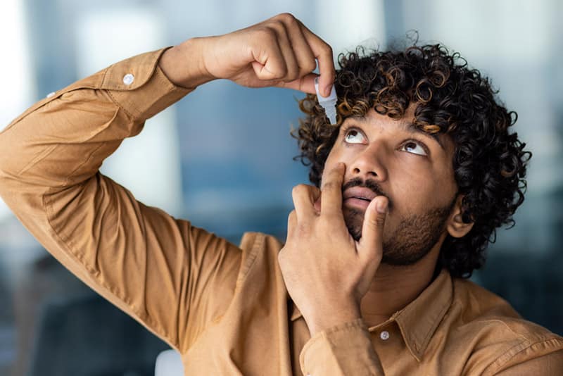 Person putting in eye drops