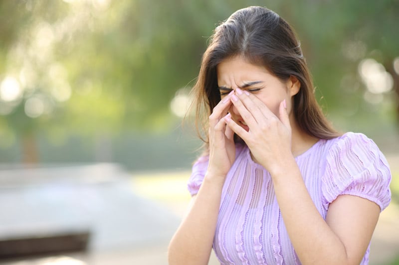 Woman rubbing her eyes due to dry eye